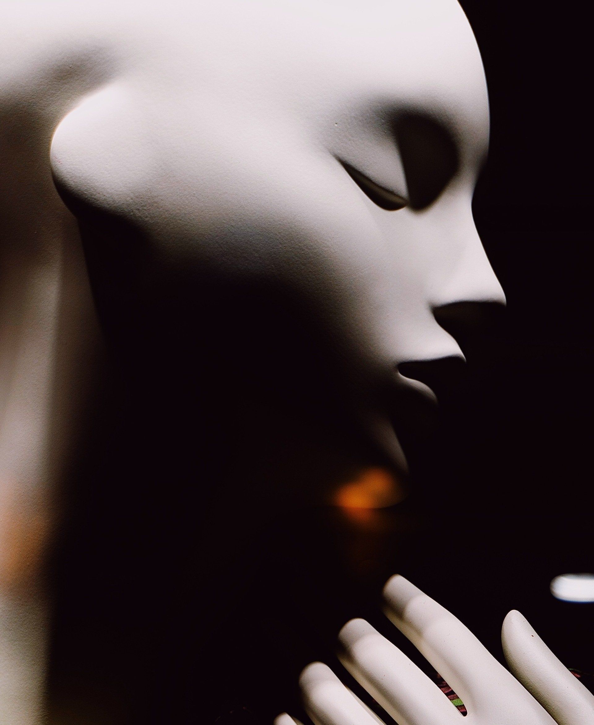 A close up of a mannequin 's face with its eyes closed