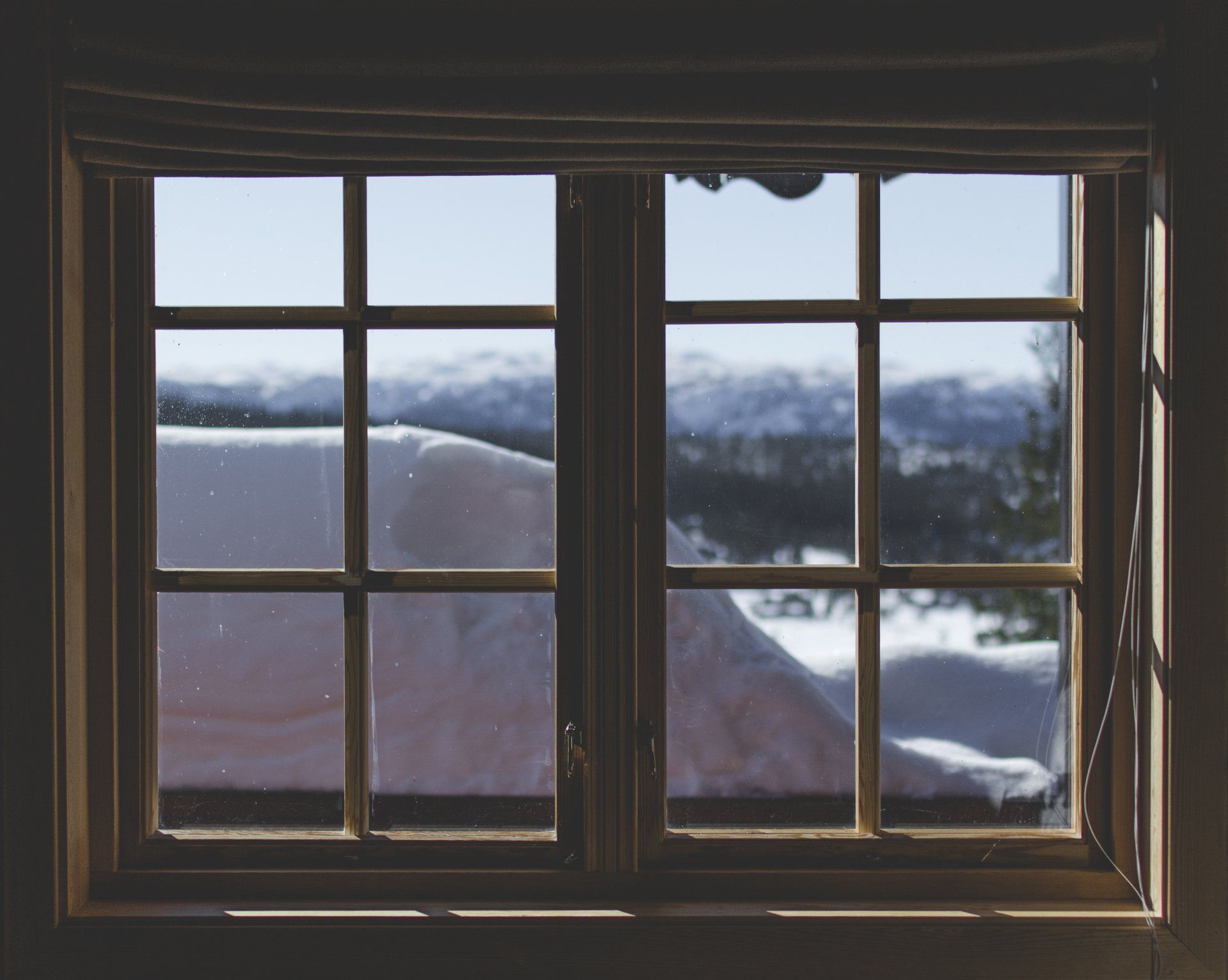 View of the snow-covered mountains through a window