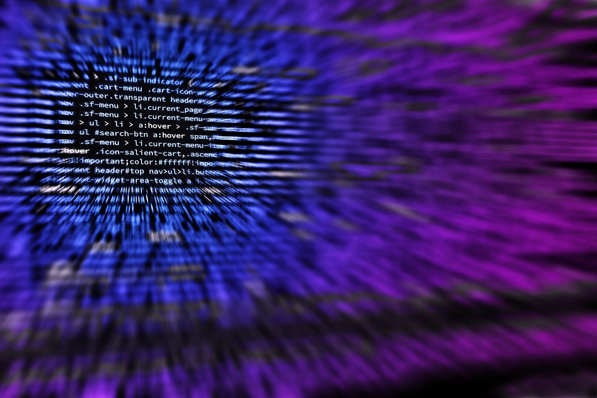 A blurry image of a blue and purple background with computer code.