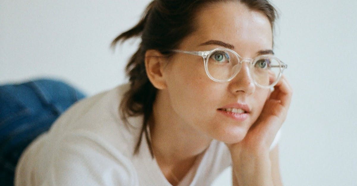 woman in white shirt wearing clear glasses