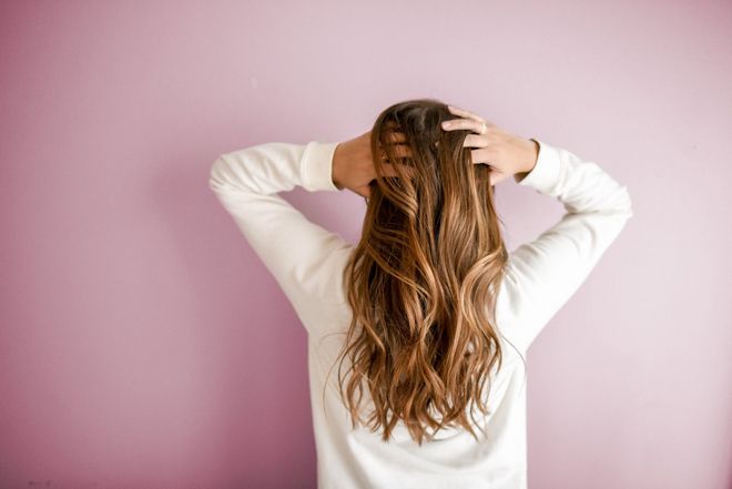 A picture of a woman running her fingers through her hair