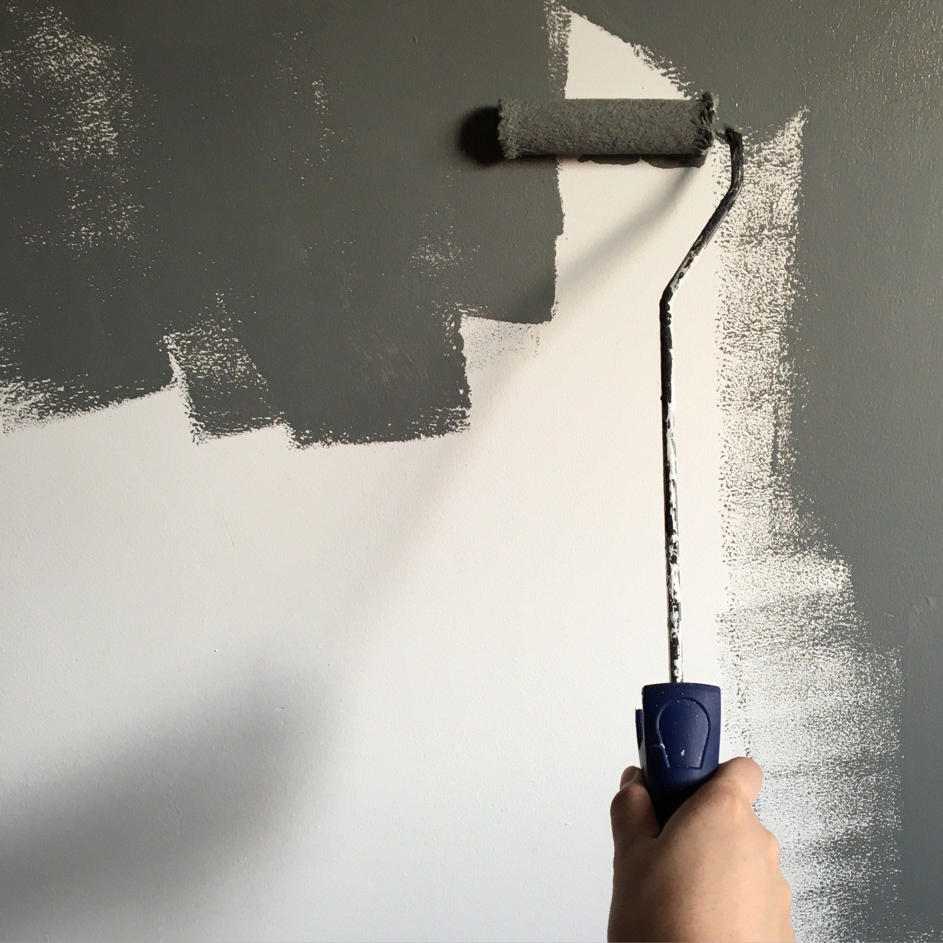 painting a wall using roller