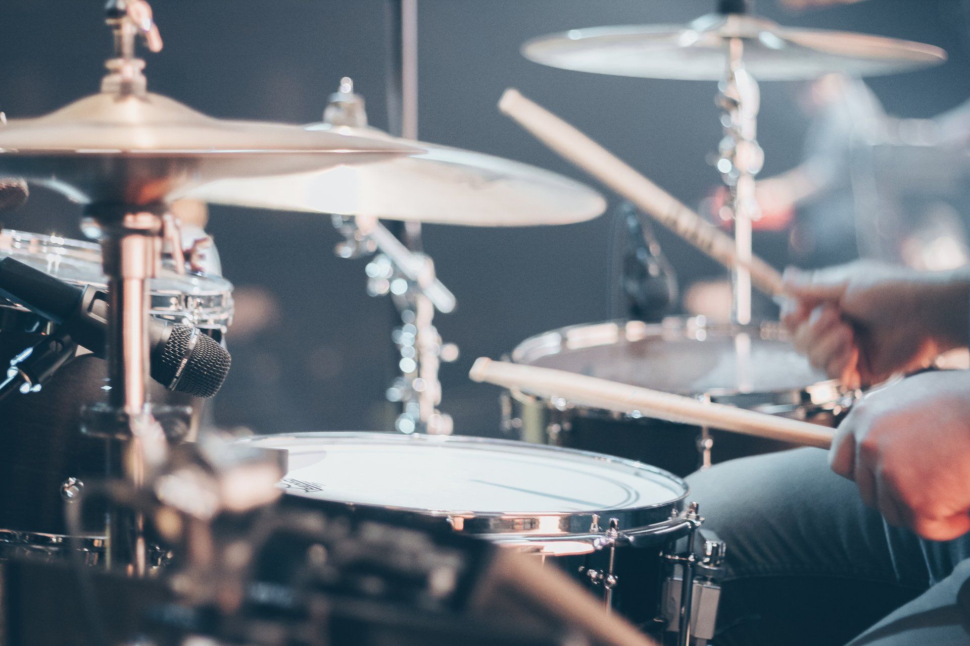 a close up of a person playing drums on a stage .