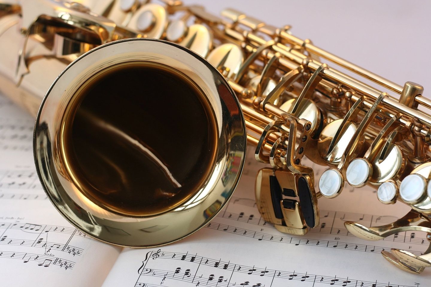 a close up of a saxophone on a sheet of music