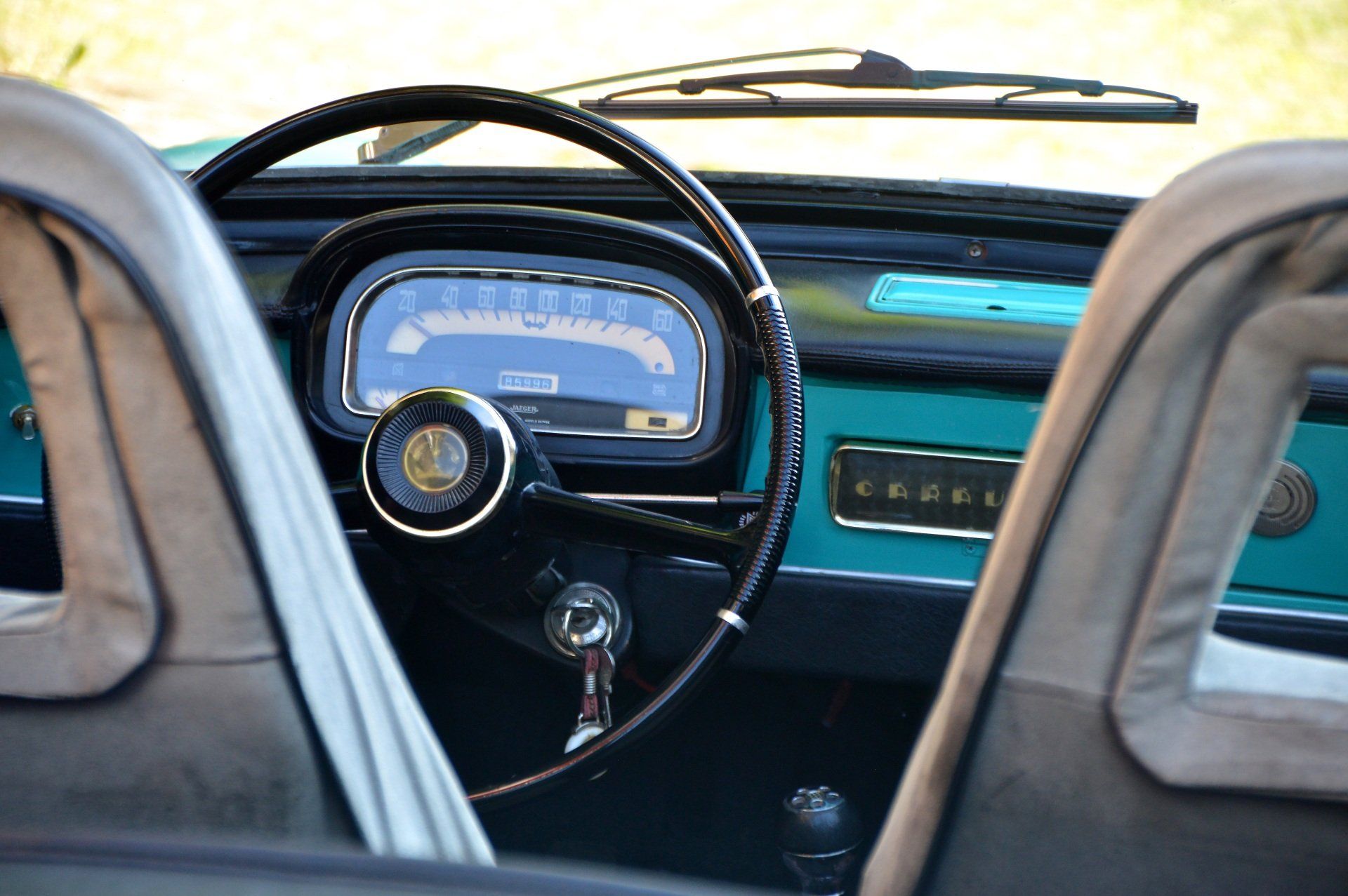 the interior of an old car with a steering wheel and dashboard .