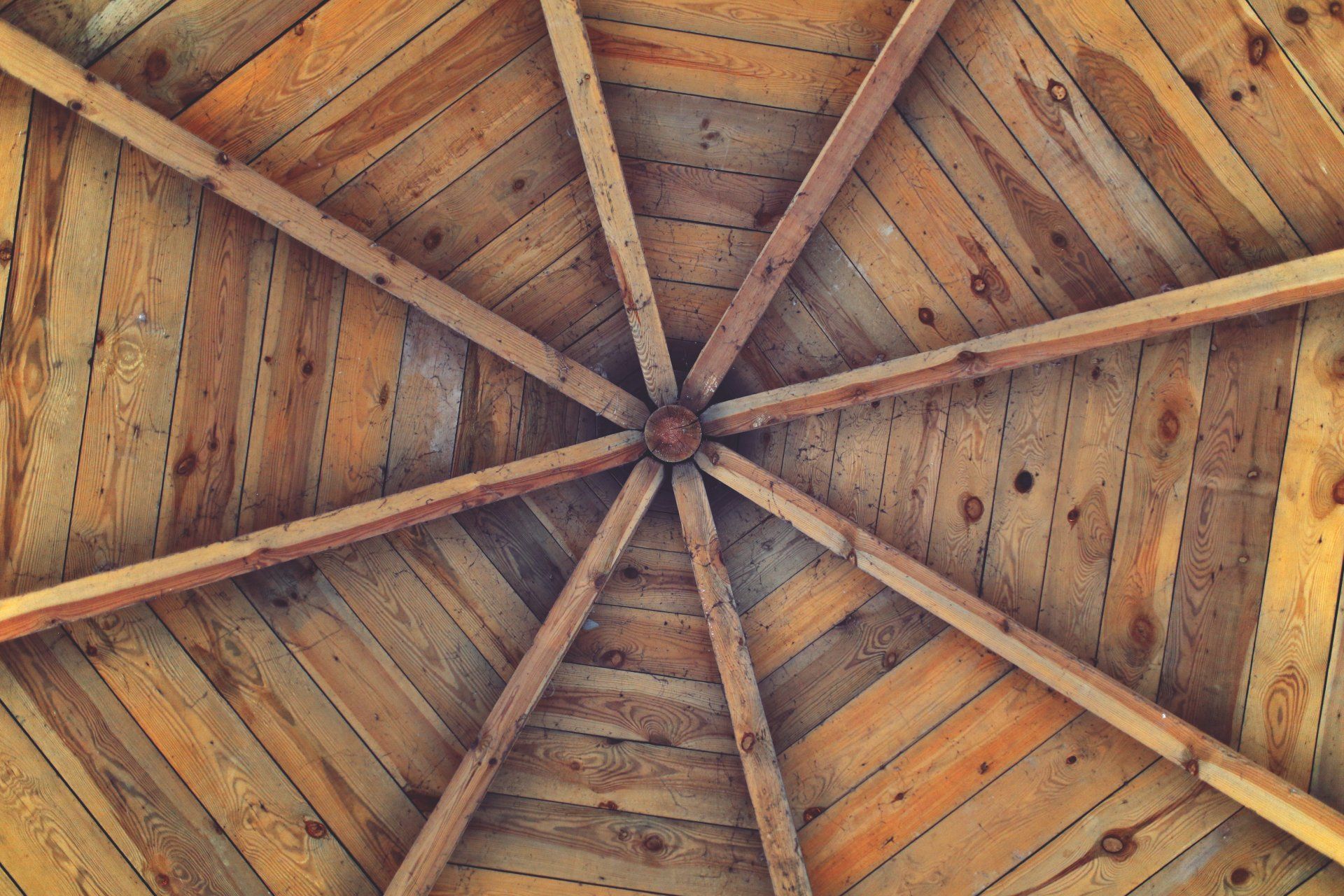 Looking up at the ceiling of a wooden structure.