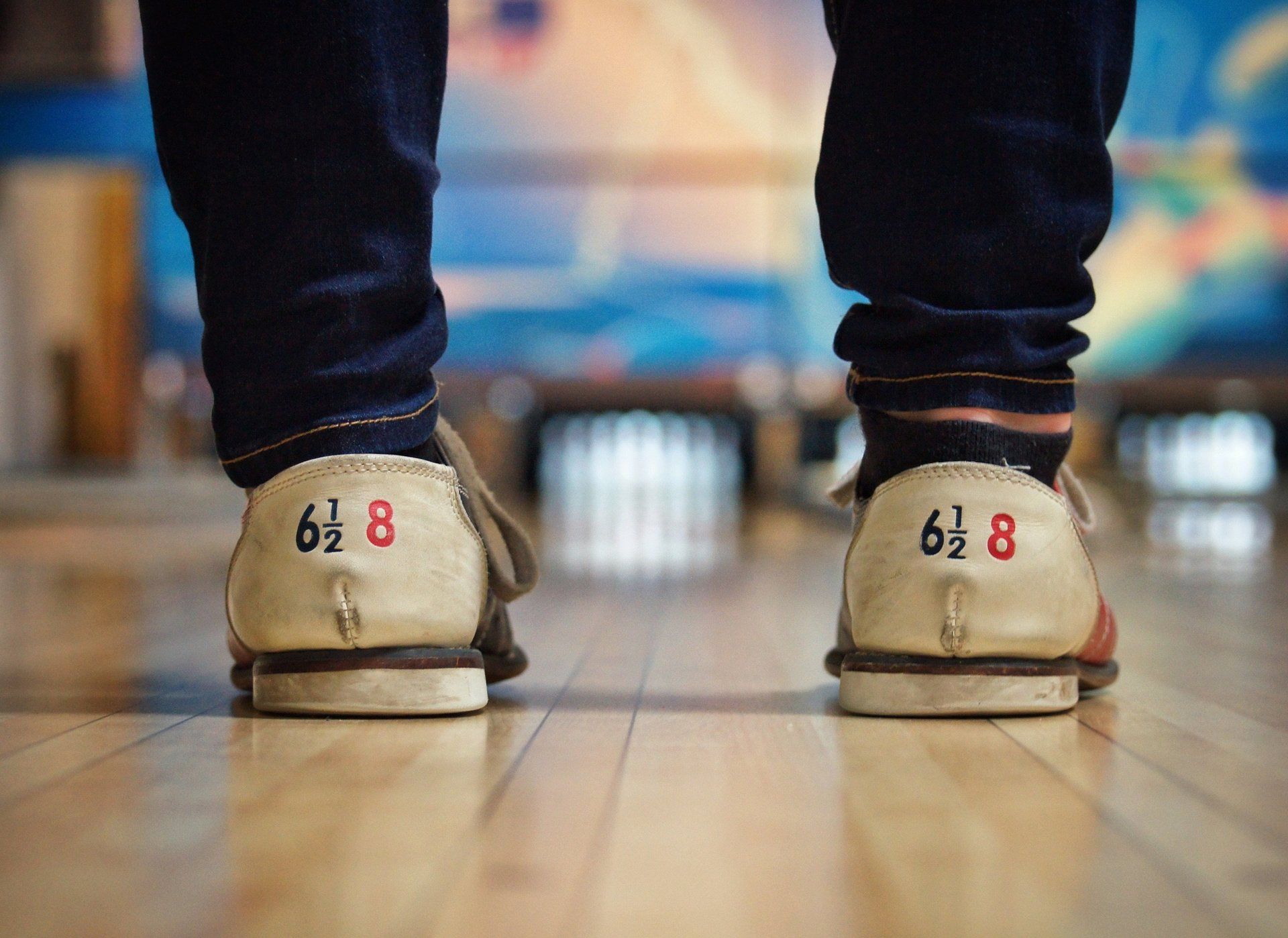 a person is wearing bowling shoes with the number 8 on them .