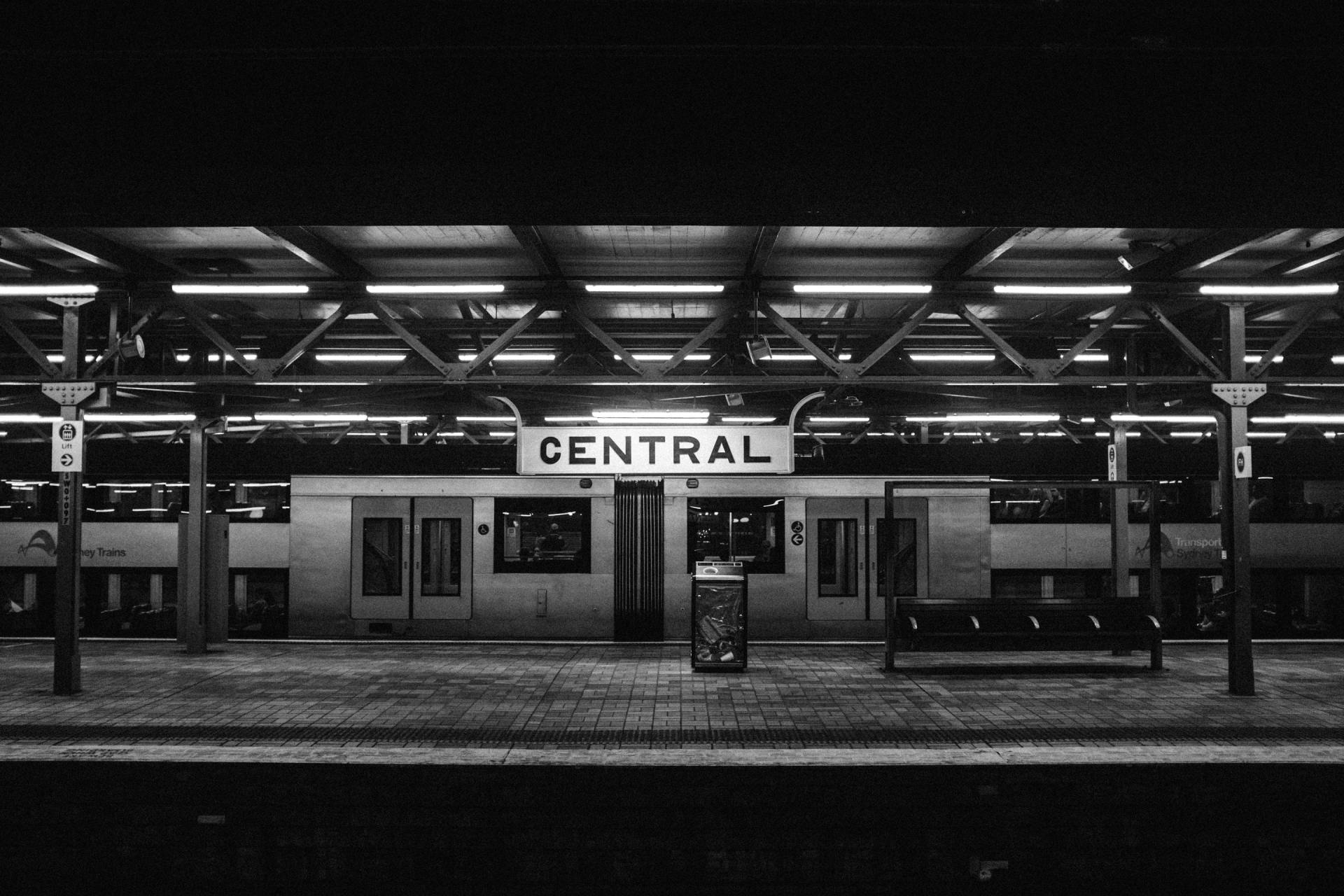 A black and white photo of a train station that says central
