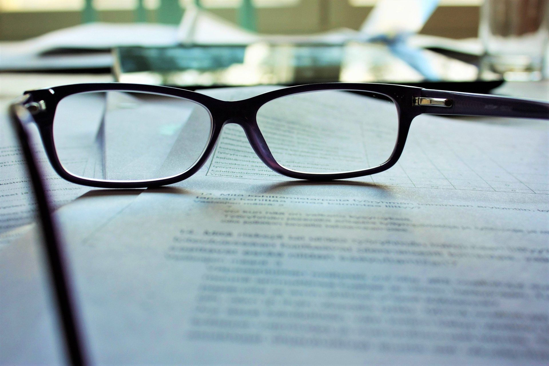 Glasses on a contract page sitting on a table
