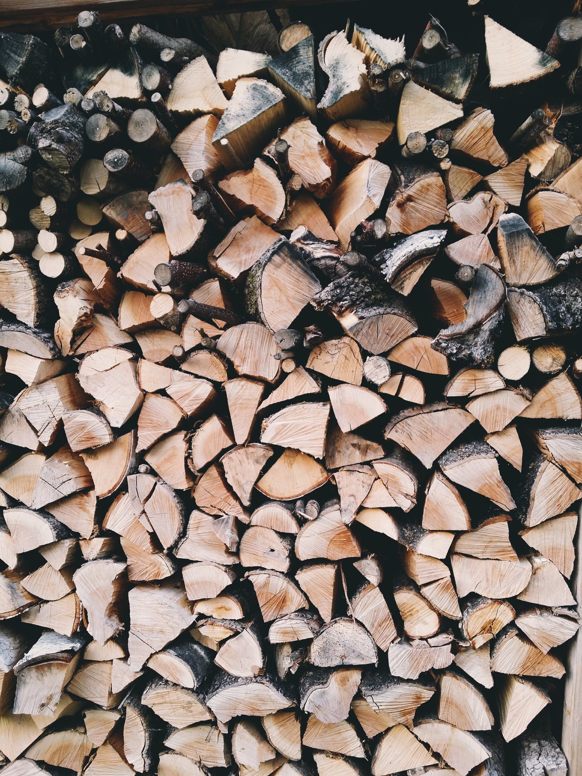 A pile of chopped wood is stacked on top of each other.