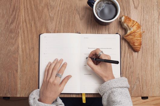 woman writing in book