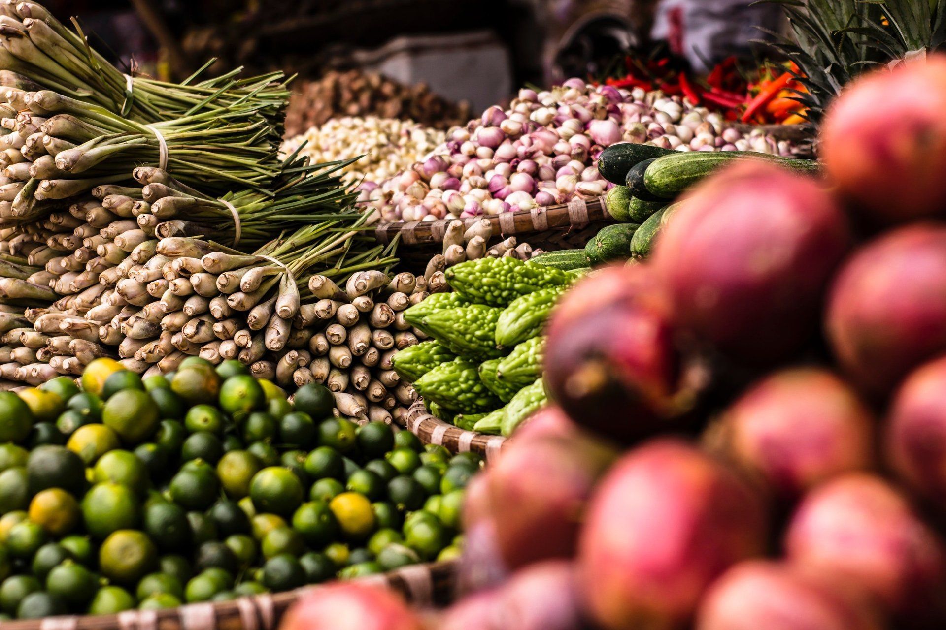 A variety of fruits and vegetables are on display at a market.