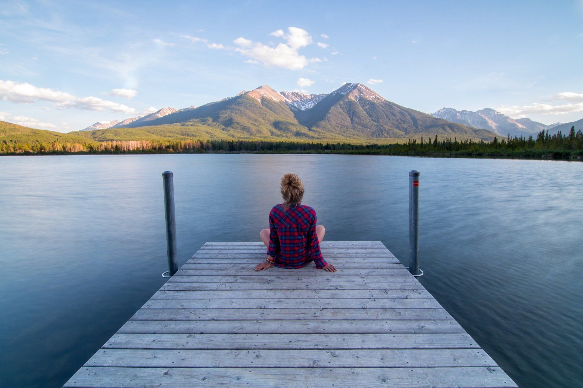 woman meditating with arms resting on knees and legs folded Indian style