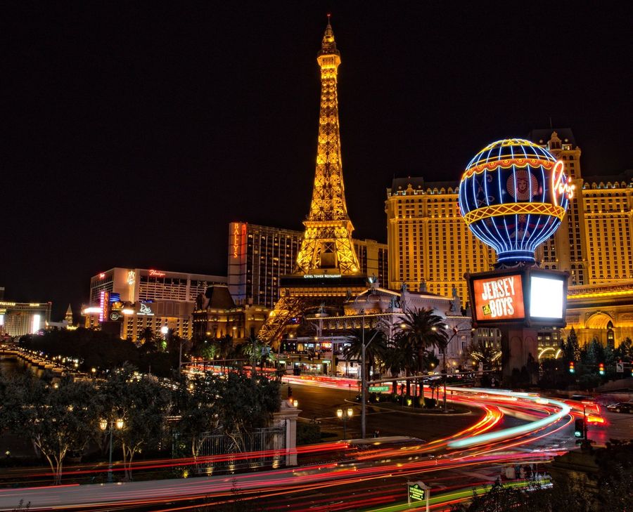 The eiffel tower is lit up at night in las vegas