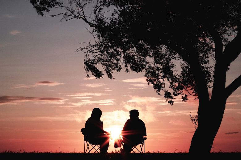 two seniors enjoying sunset