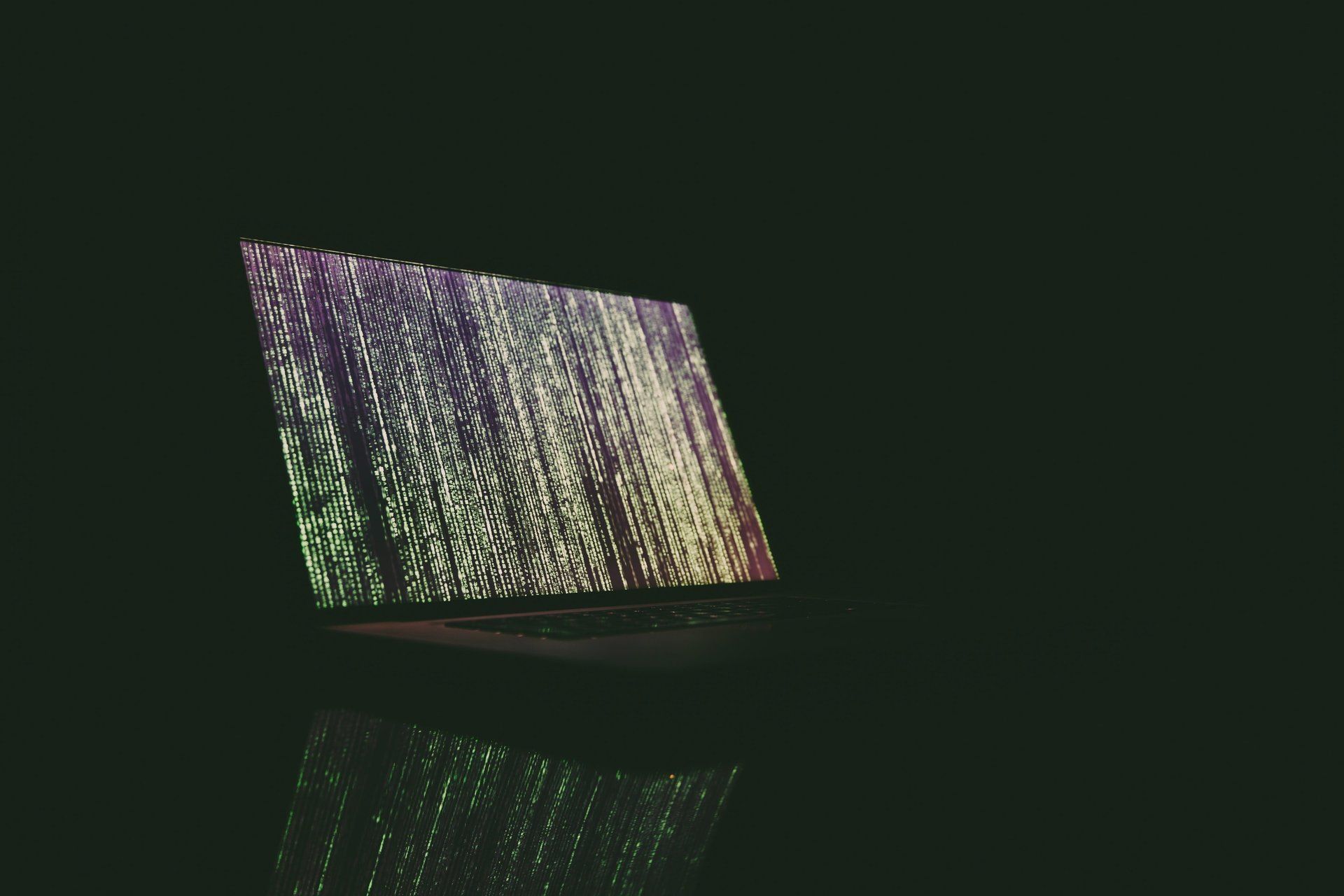 Laptop screen, dark room, code on screen,
