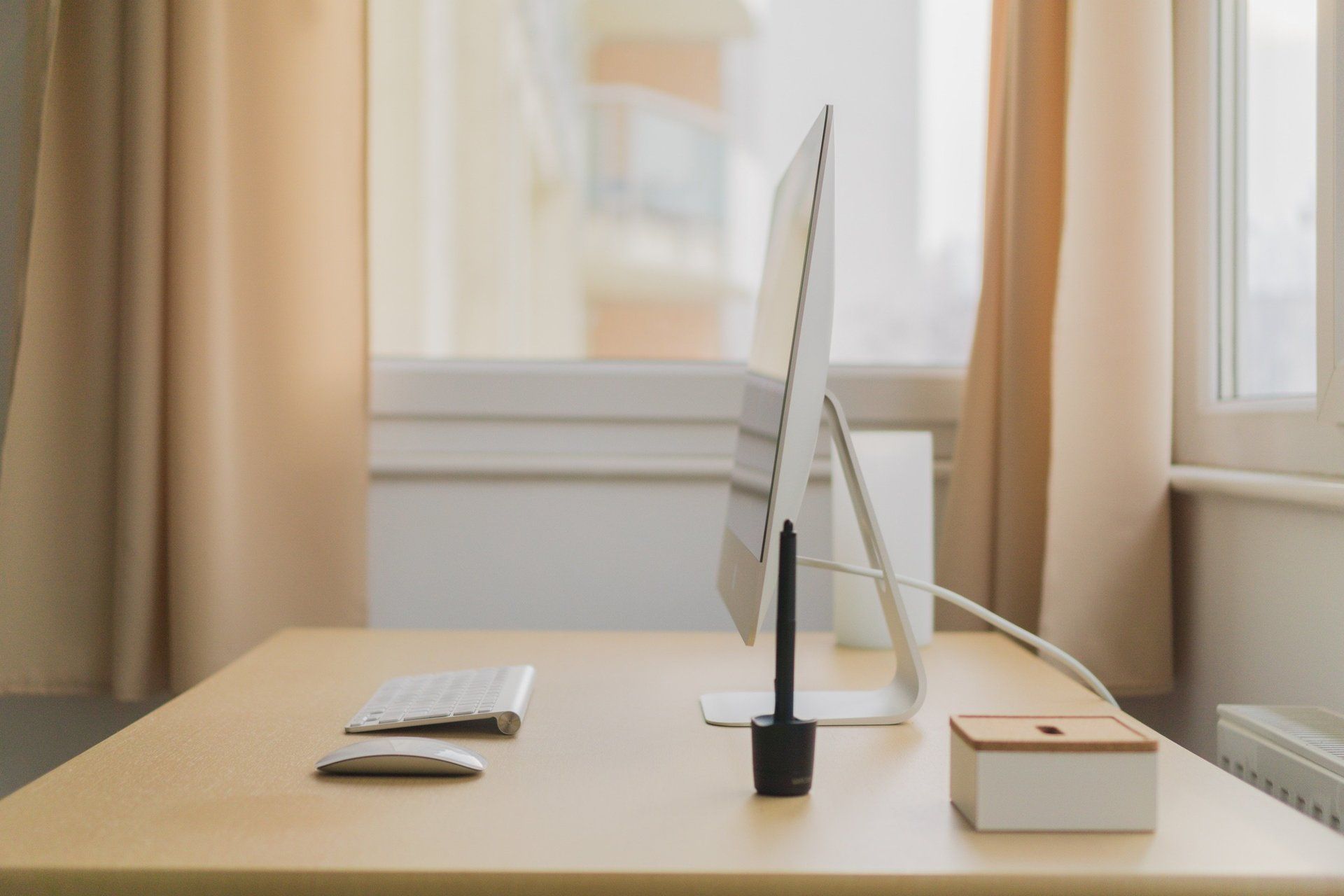 Tidy minimalist desk containing screen, mouse, bod and keyboard