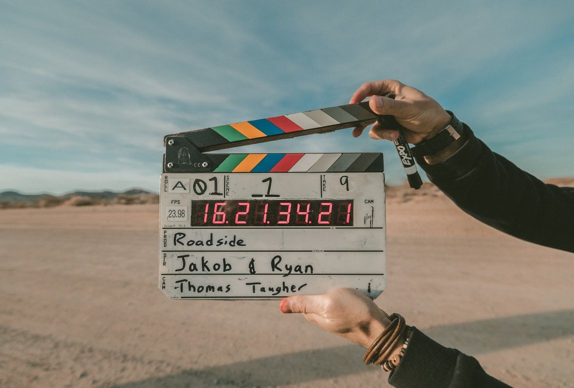 a person is holding a clapper board that says roadside