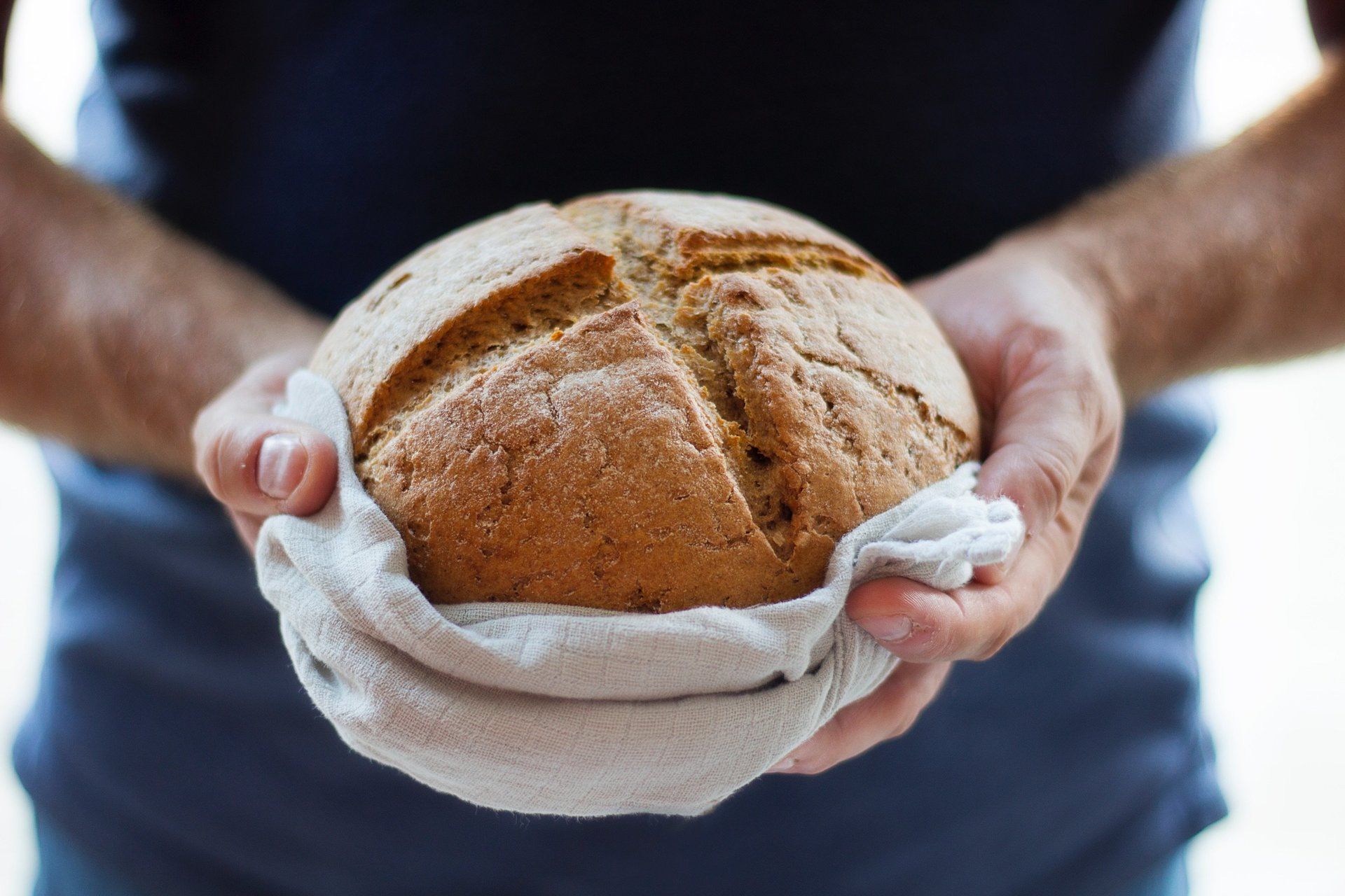 baker holding loaf of bread
