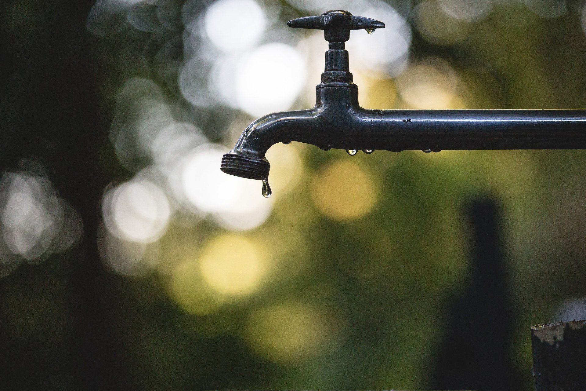 A close up of a faucet with water dripping from it