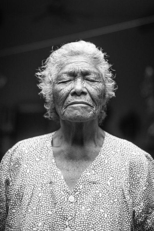 older woman with eyes closed and wrinkles across face