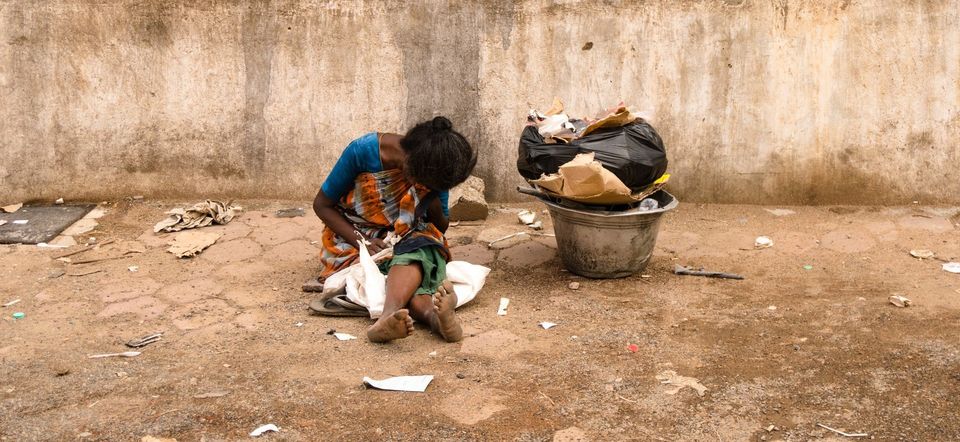 woman suffering poverty surrounded by trash