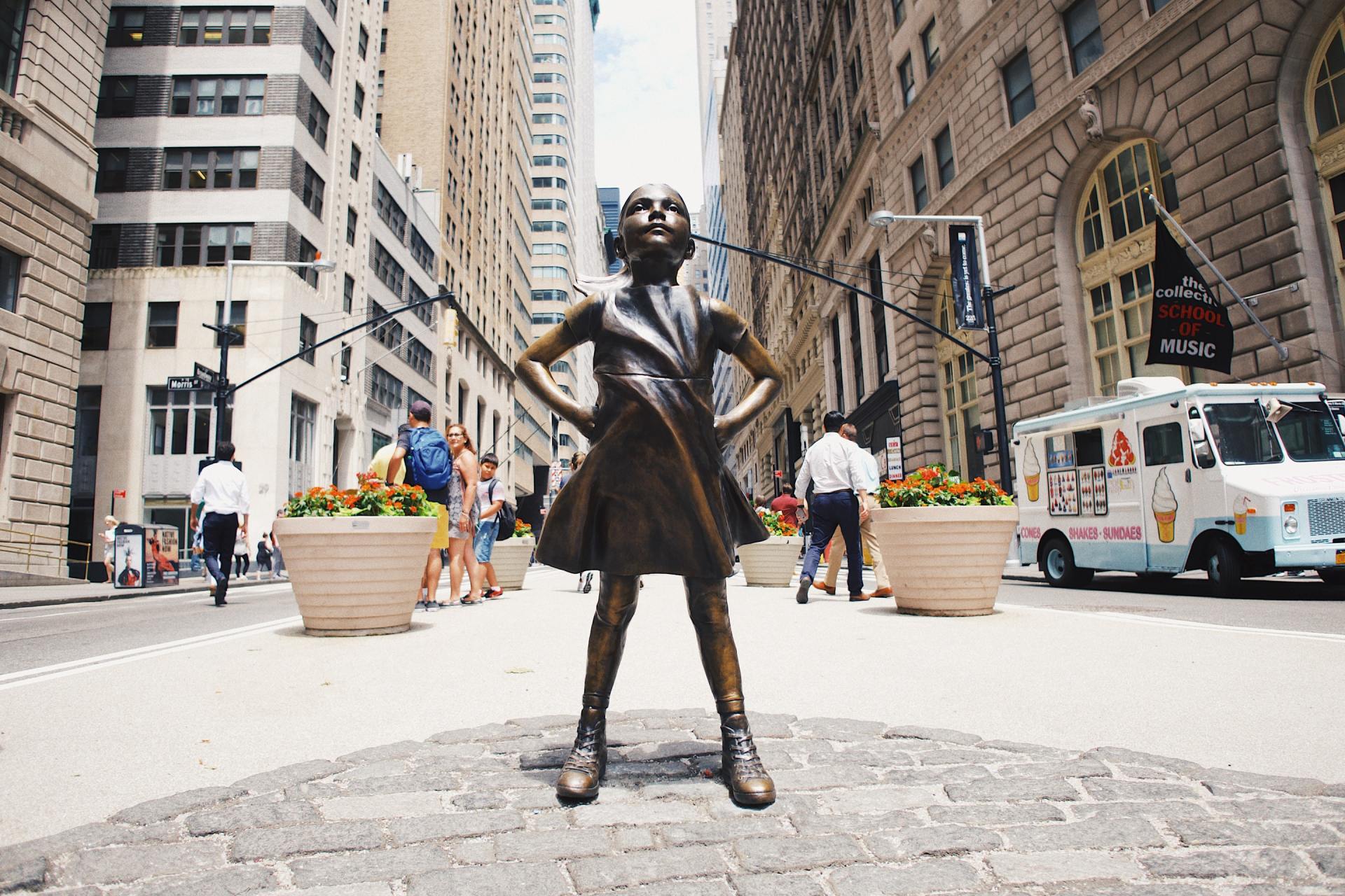 a statue of a girl with her hands on her hips