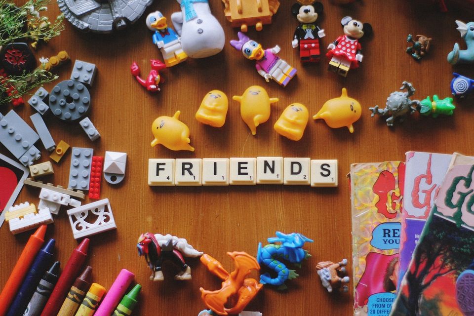 children's toys and scrabble blocks spell friends