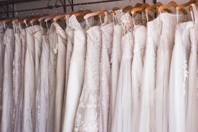 row of wedding dresses on hangers