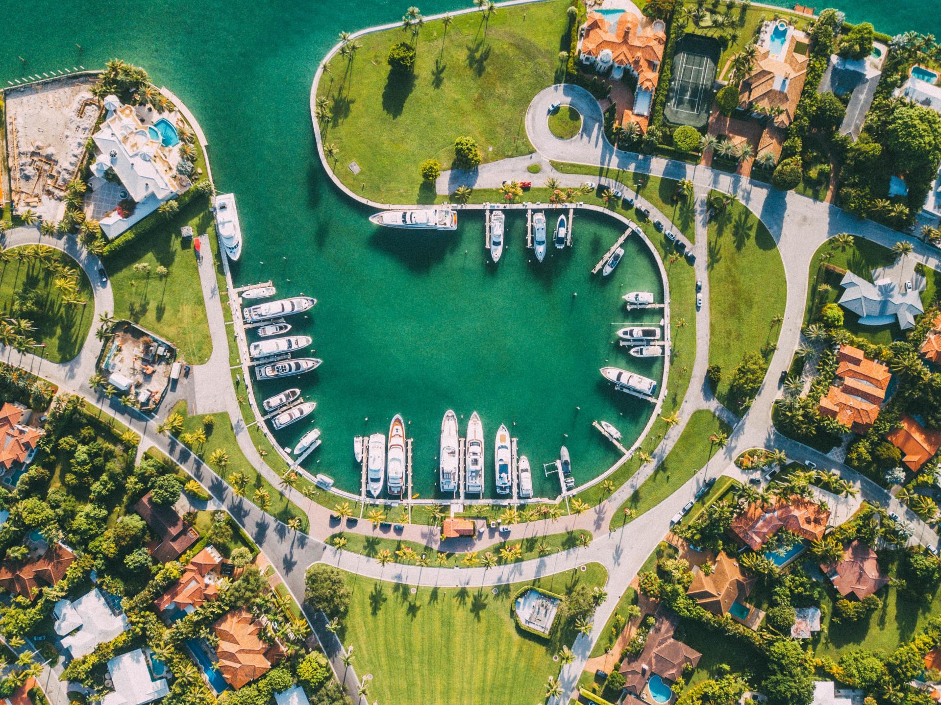 An aerial view of a residential area with boats docked in the water