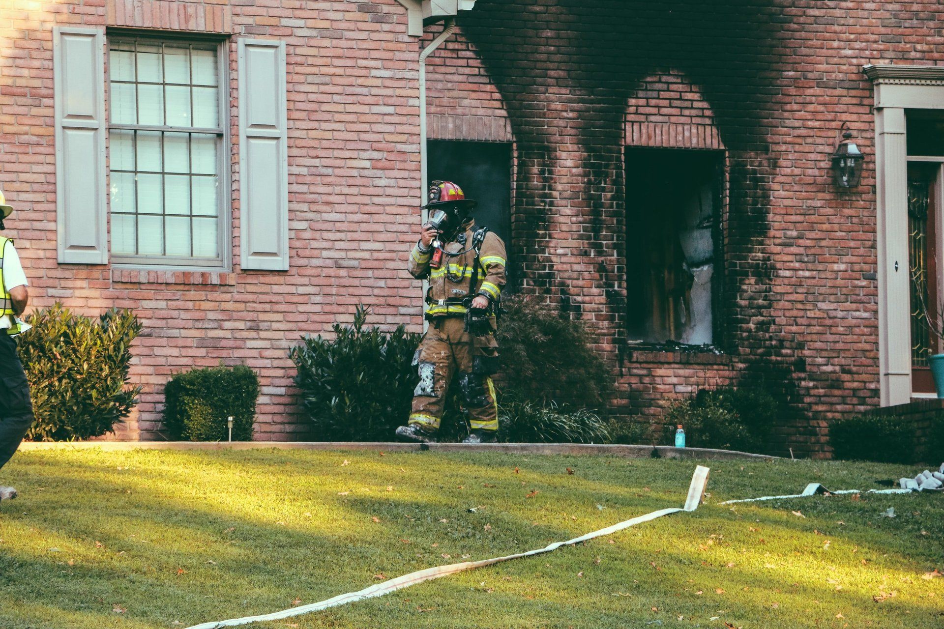 Fireman outside of burned house