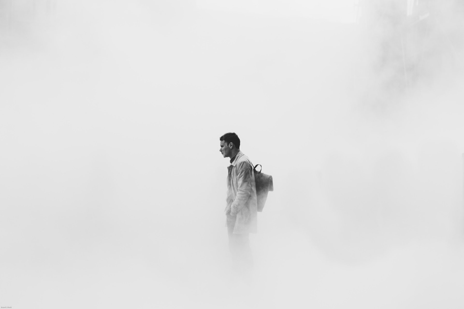 human appears to be walking on cloud like ground wearing white with something on back