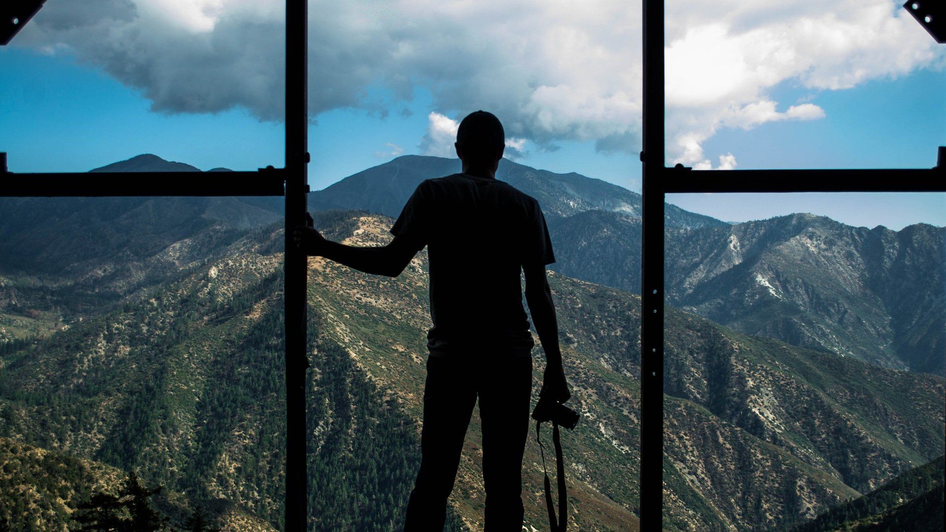 man standing in front of  the window