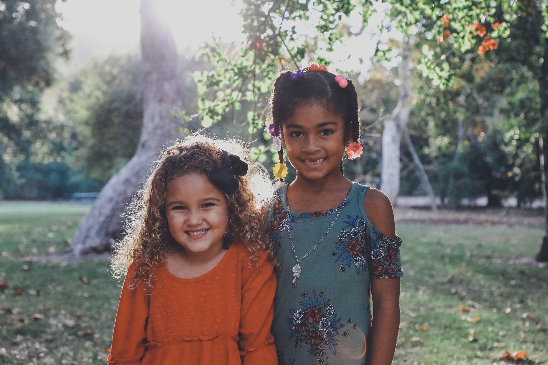 two young smiling girls pose for picture