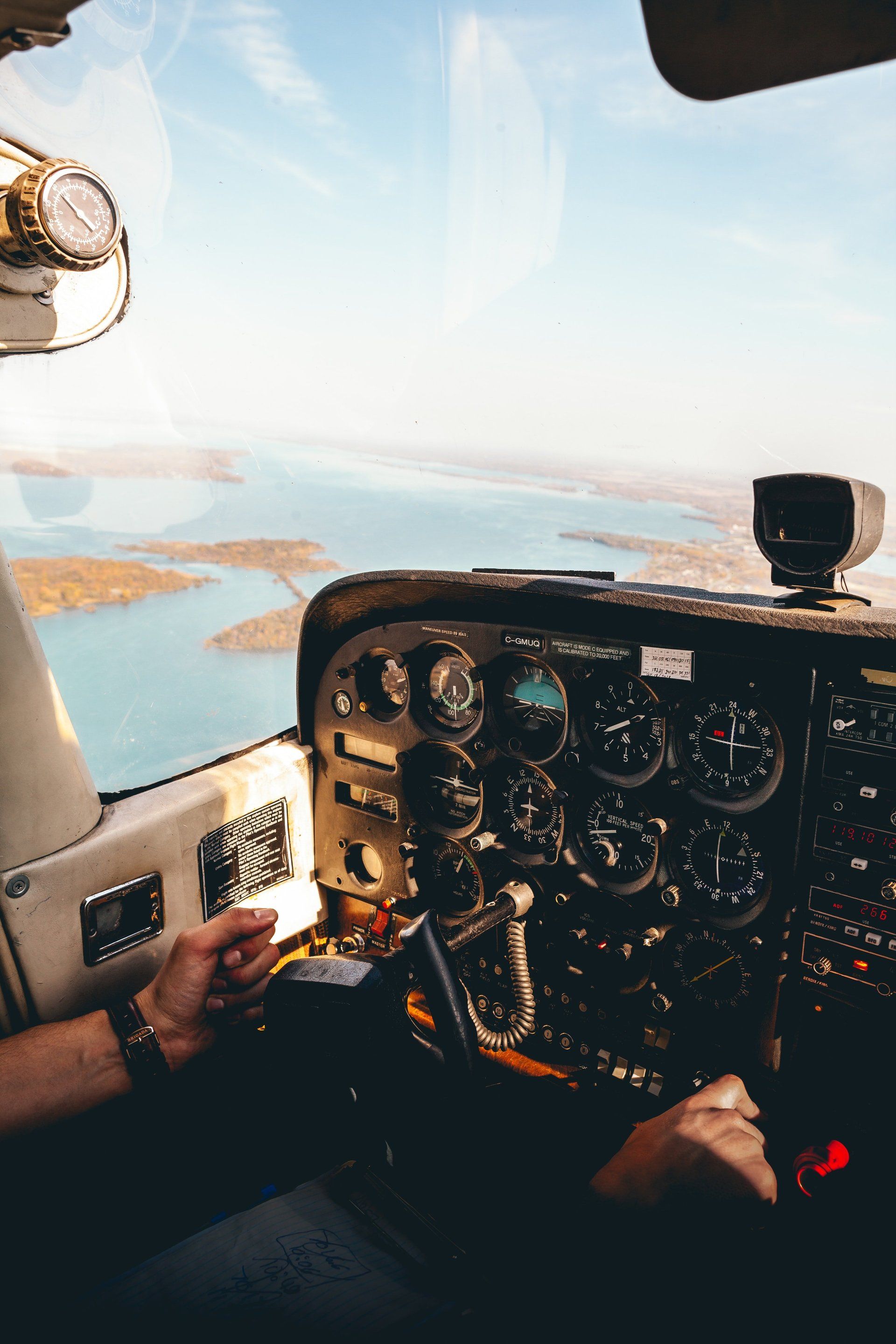A person is sitting in the cockpit of an airplane.