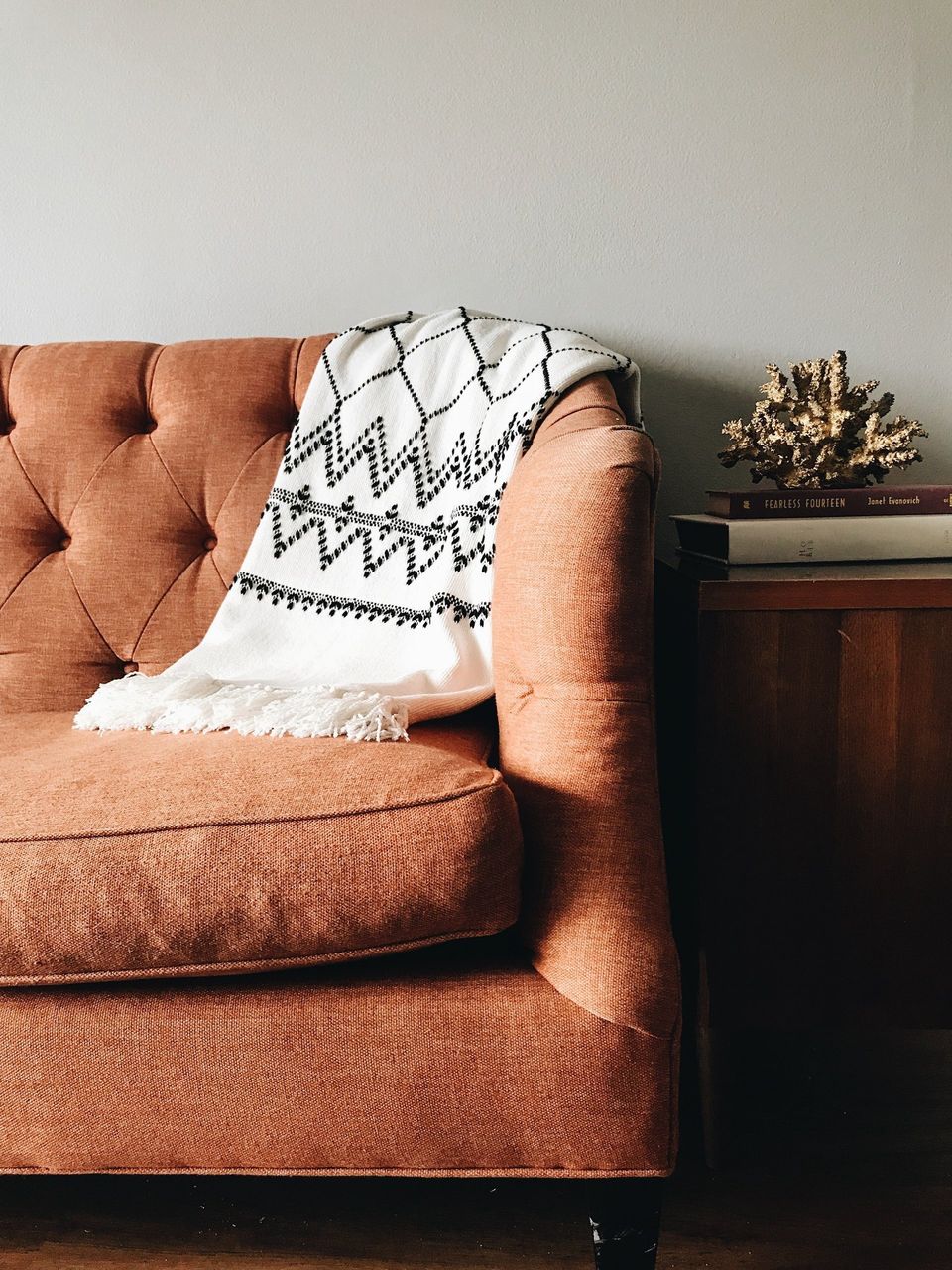 Cozy couch in living room with throw blanket