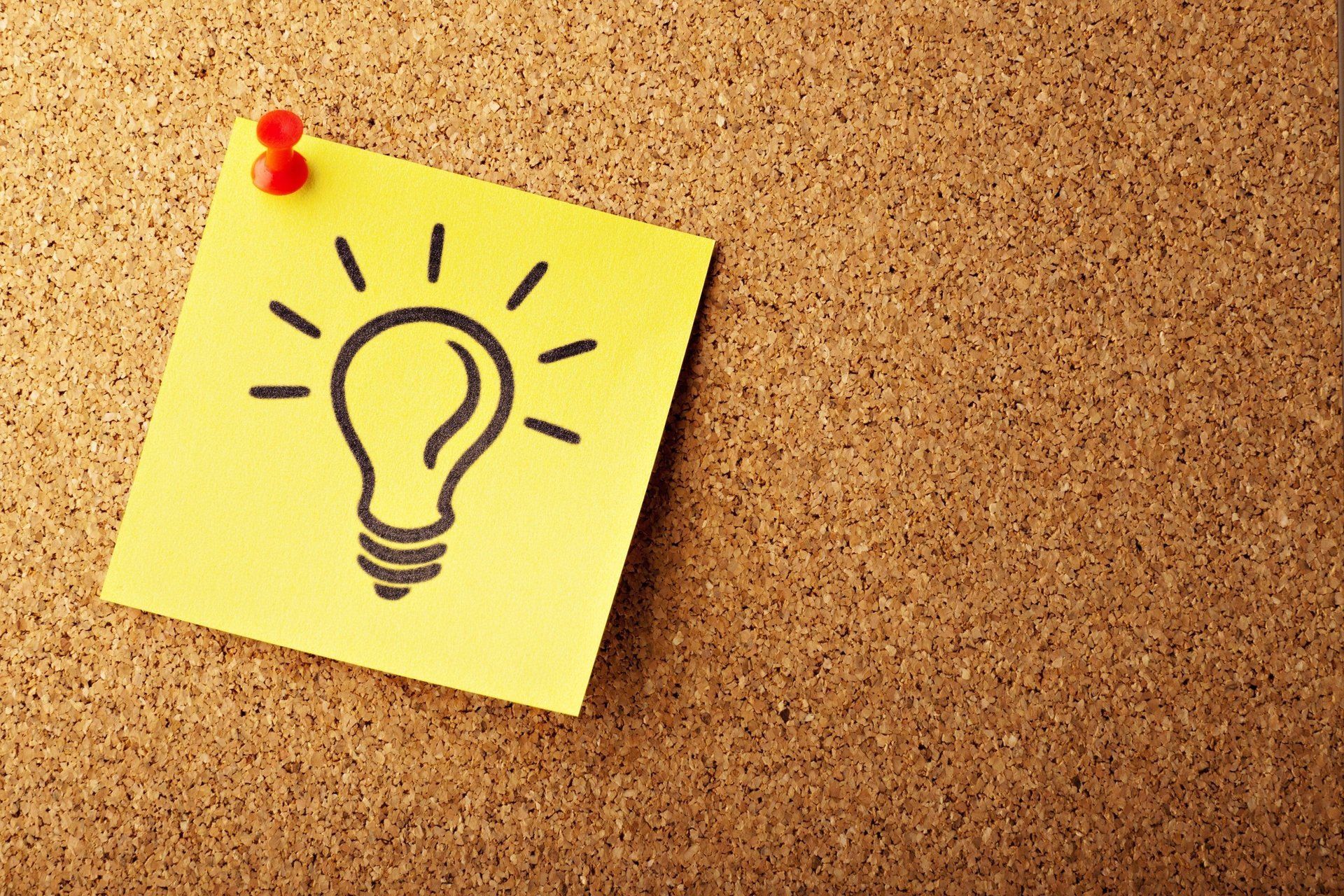 yellow sticky note with a light bulb illustrated on it
