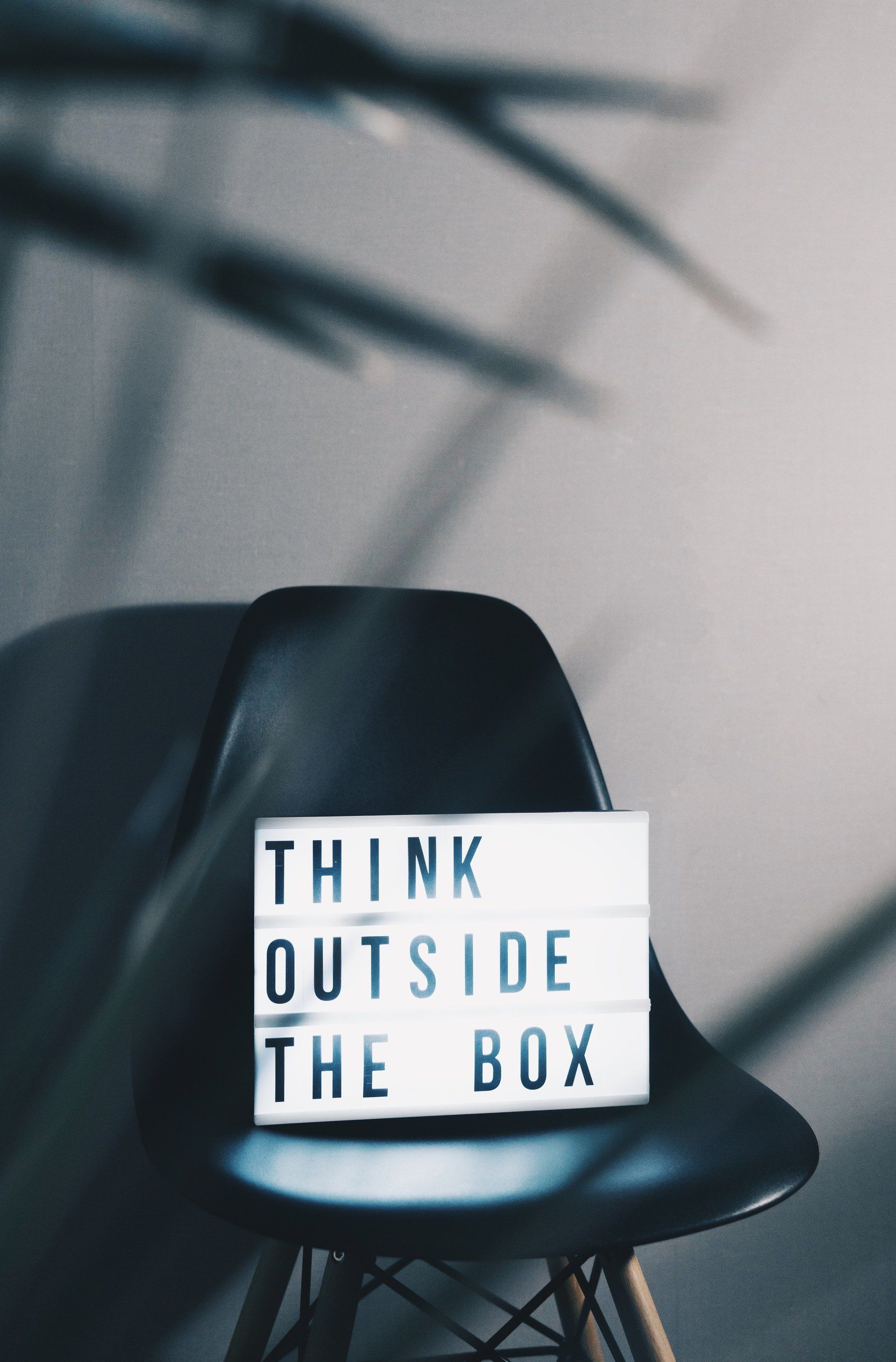a sign on a chair that says think outside the box