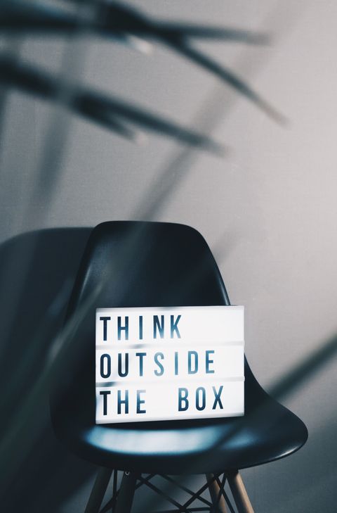 think outside the box sign on a chair