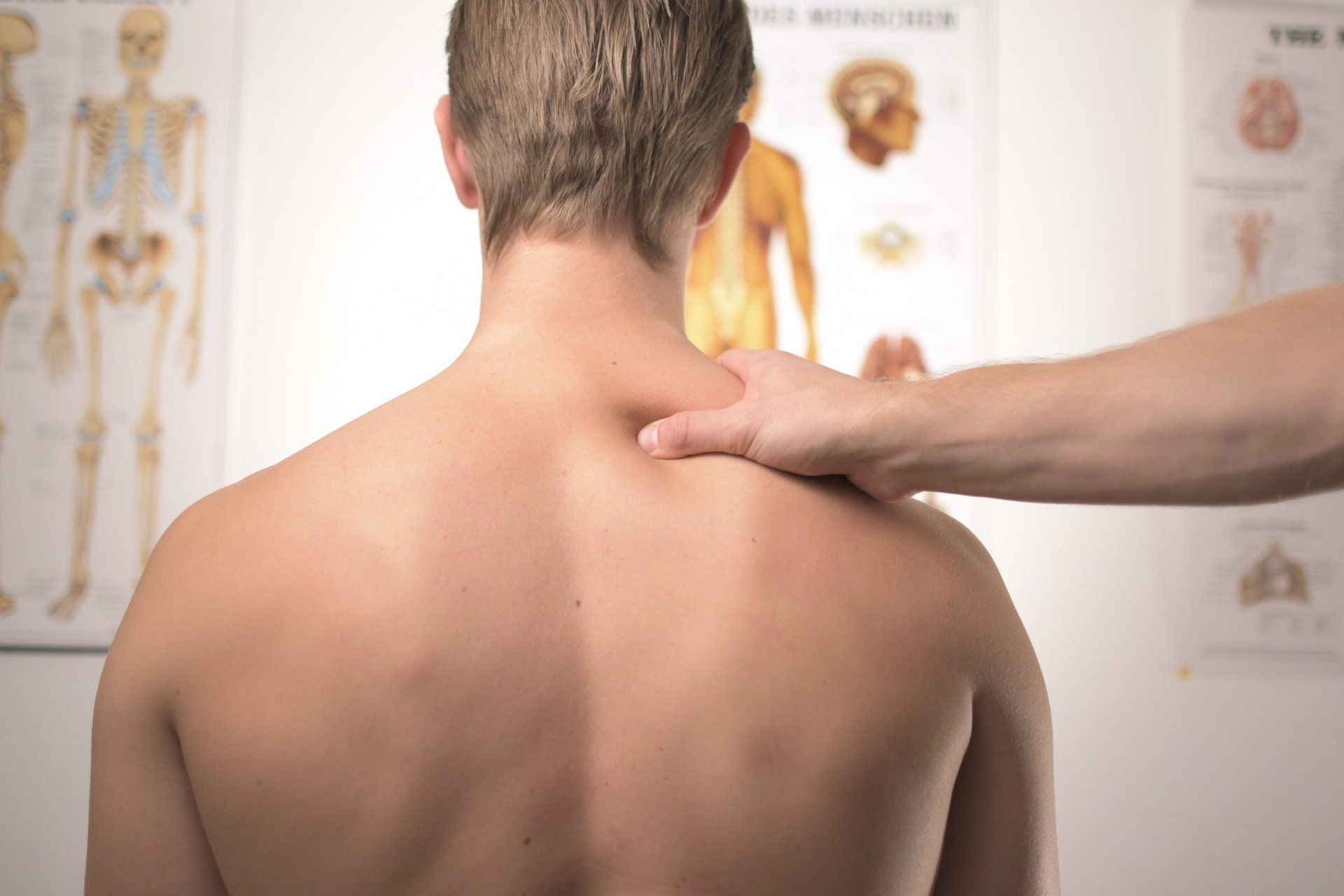 chiropractor evaluating patient's back pain
