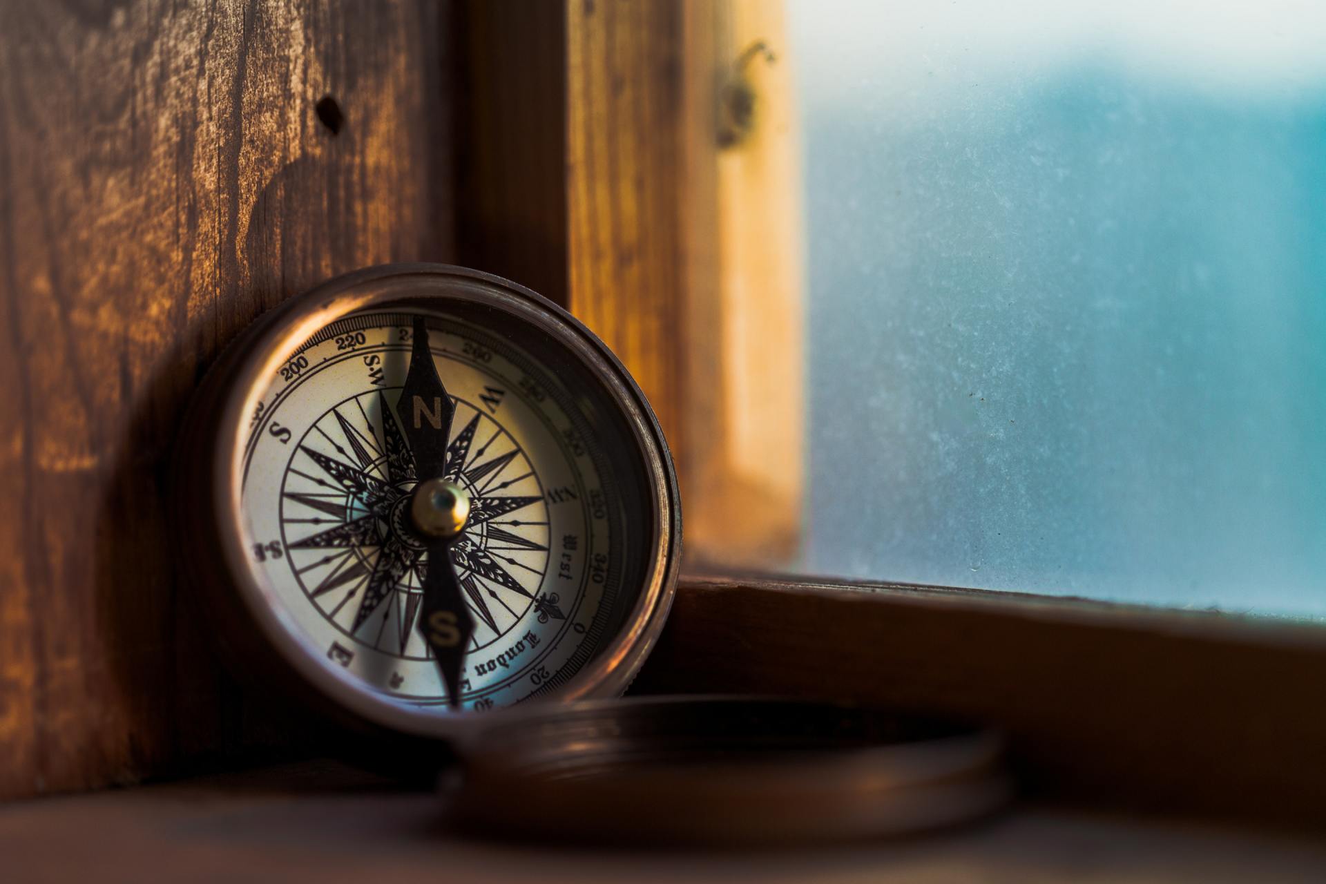 Weathered compass on a window sill