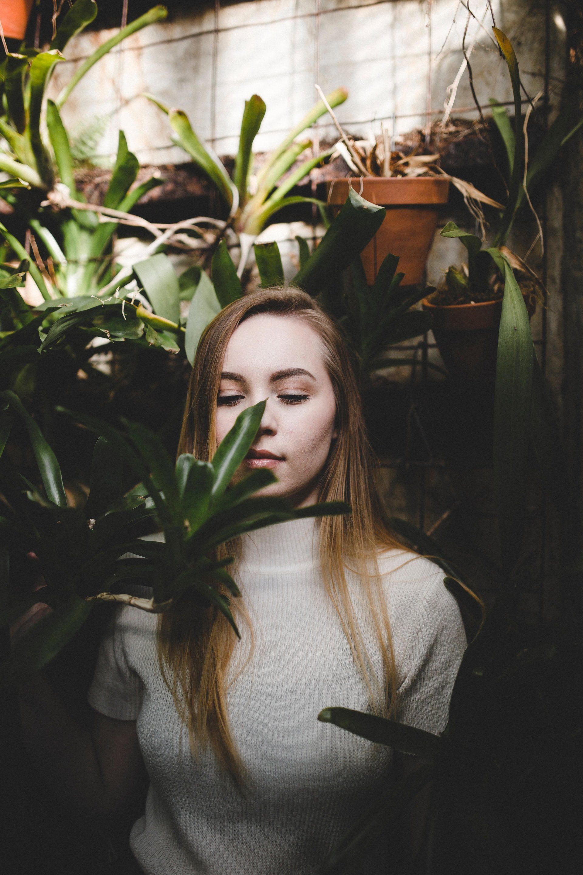 Beautiful girl smelling plants