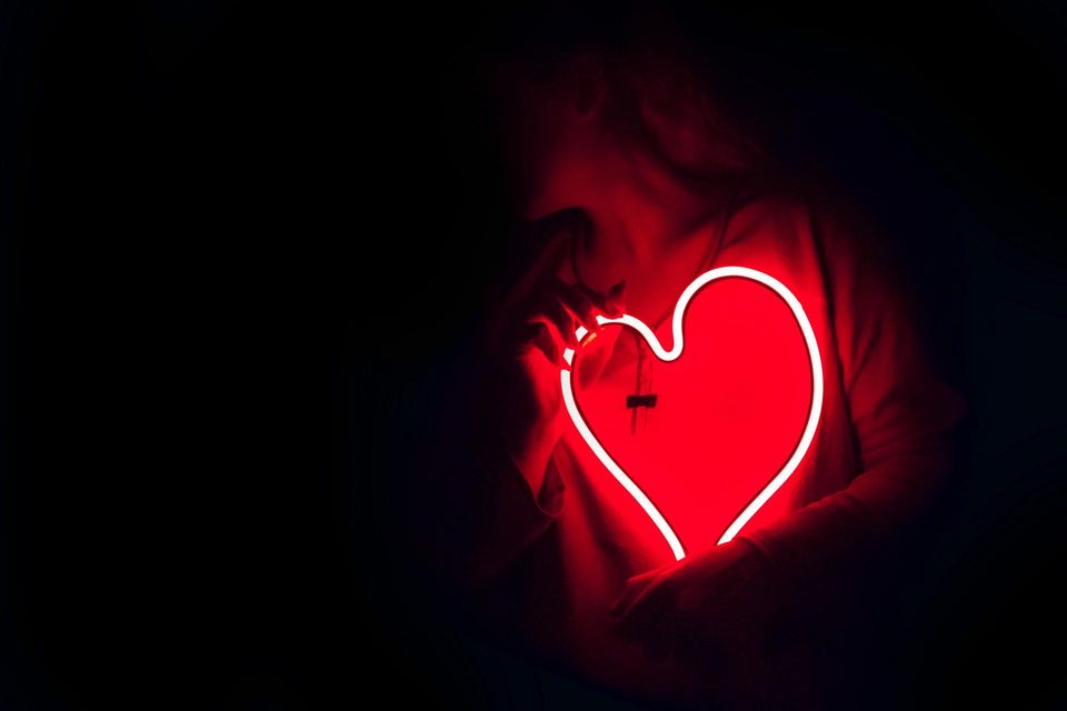 Woman with a heart-shaped Neon Light