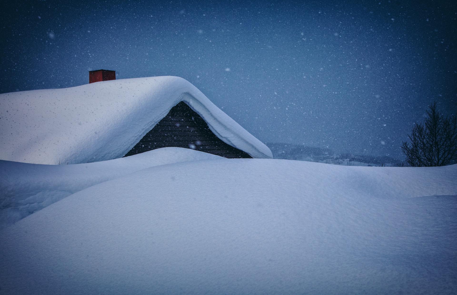 Photograph of a home with snow on the roof