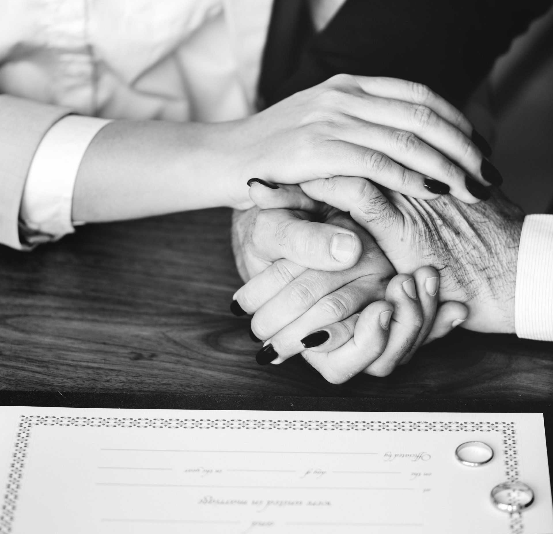A black and white photo of a man and woman shaking hands