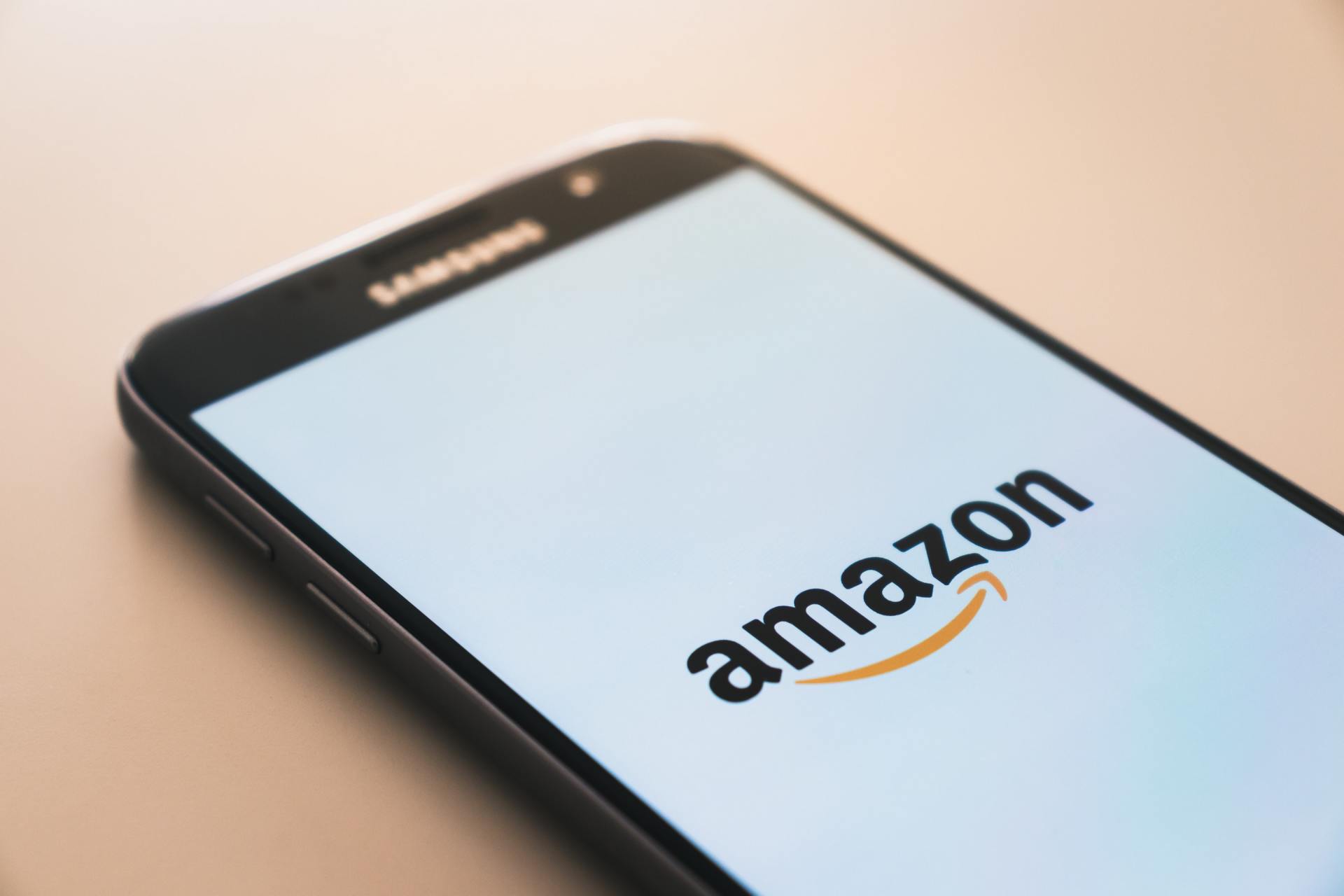 a close up of a cell phone with the amazon logo on the screen .