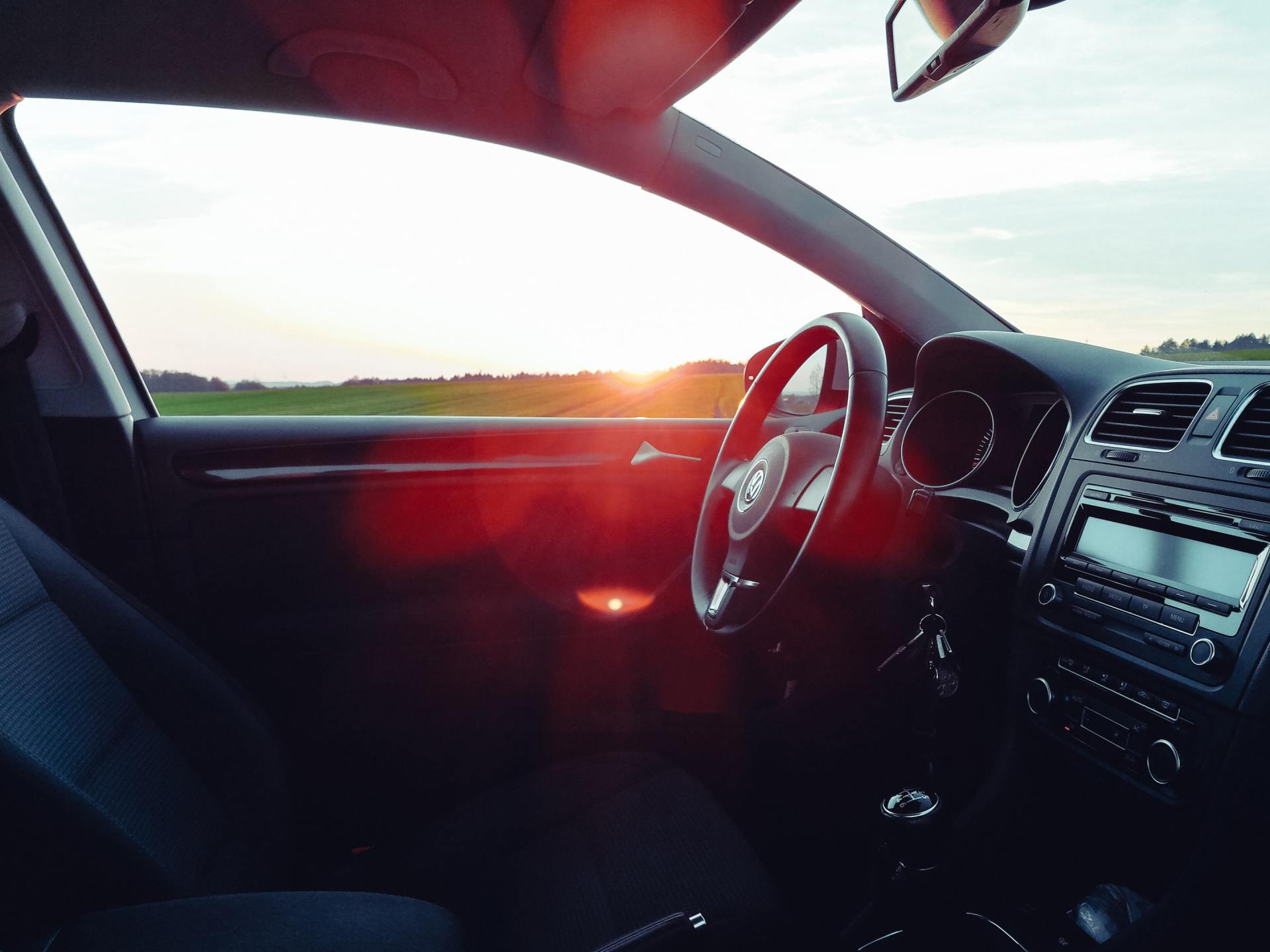 The sun is shining through the window of a car