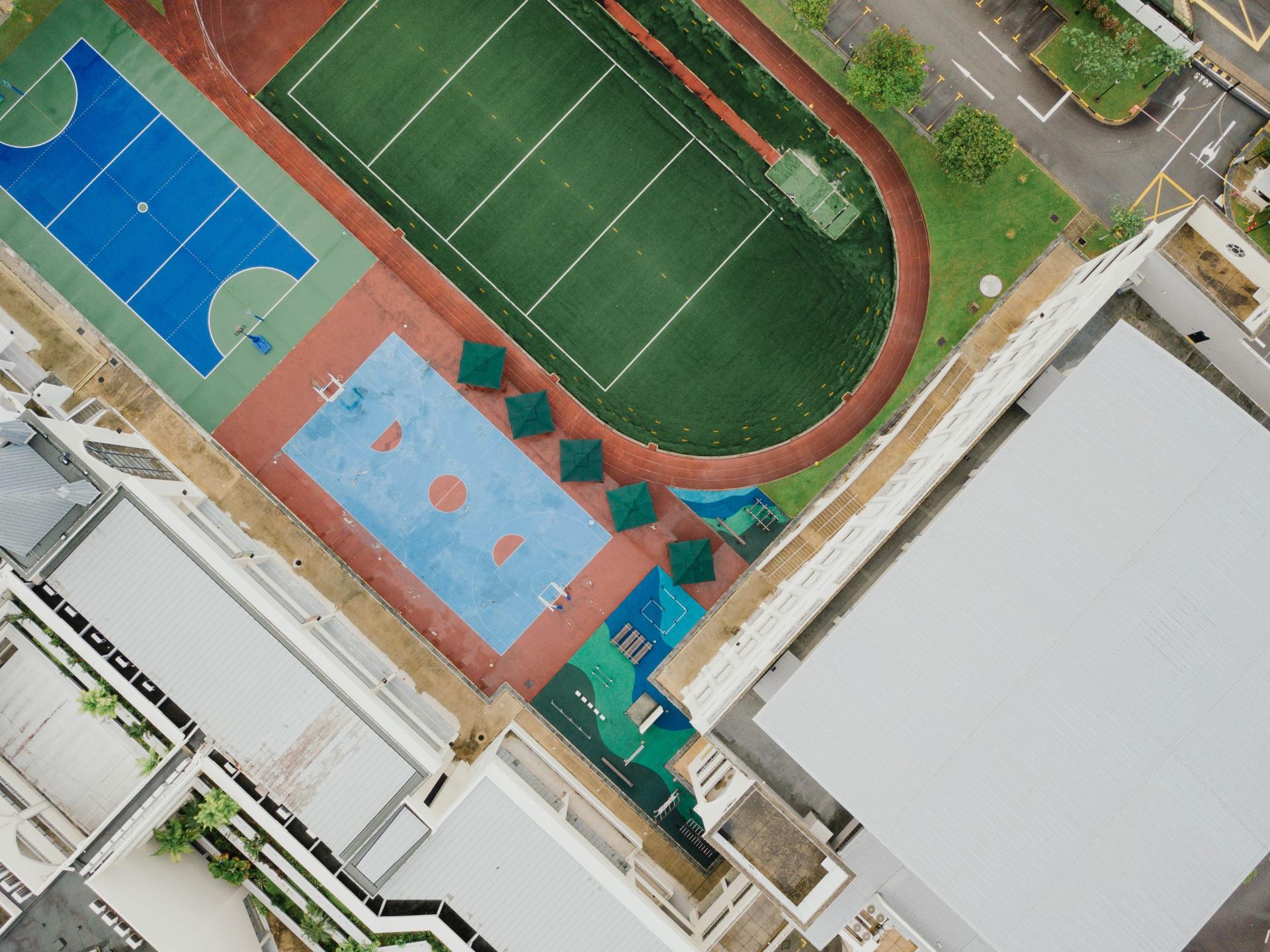 An aerial view of a tennis court and a basketball court