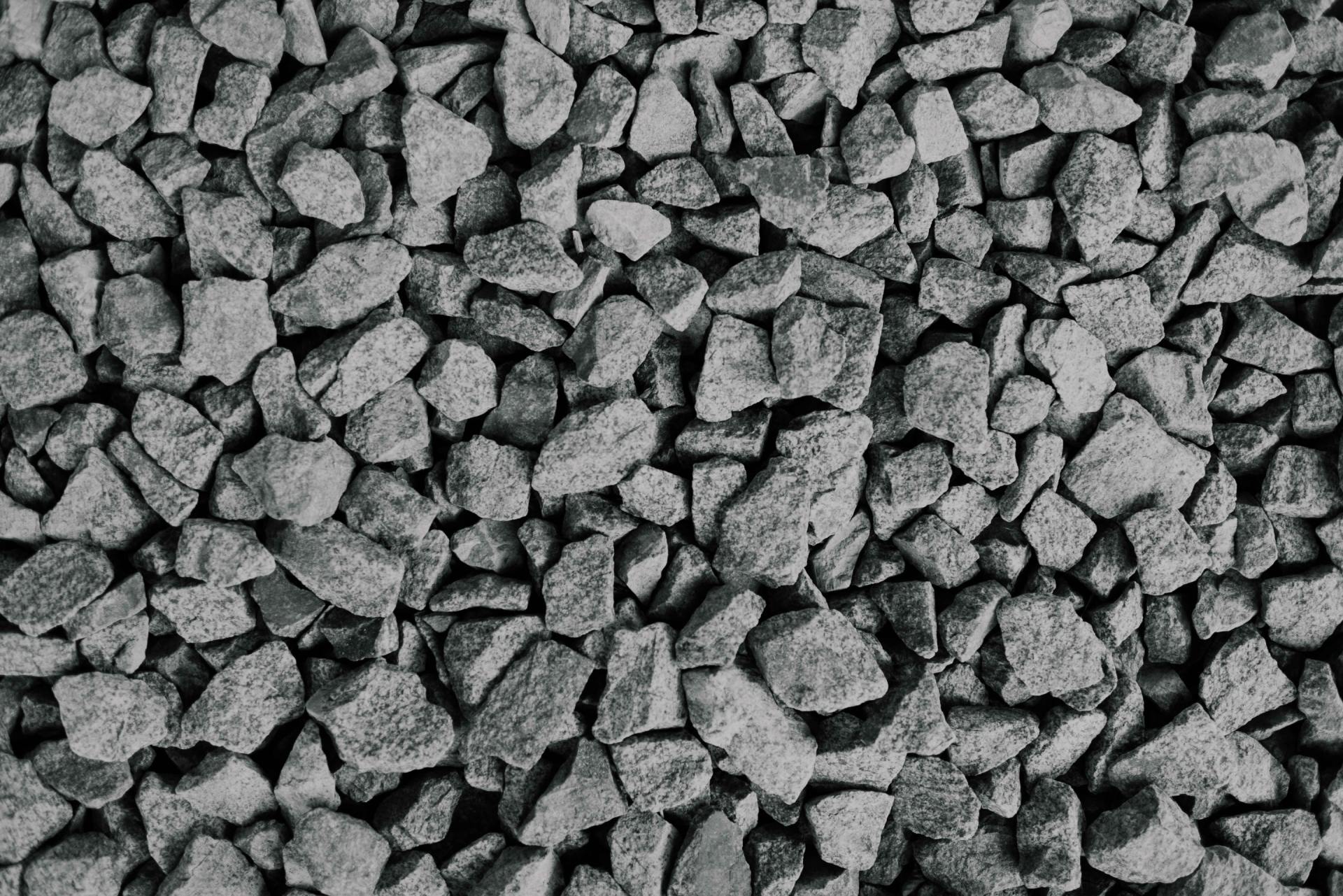 A pile of gravel is shown in a black and white photo.