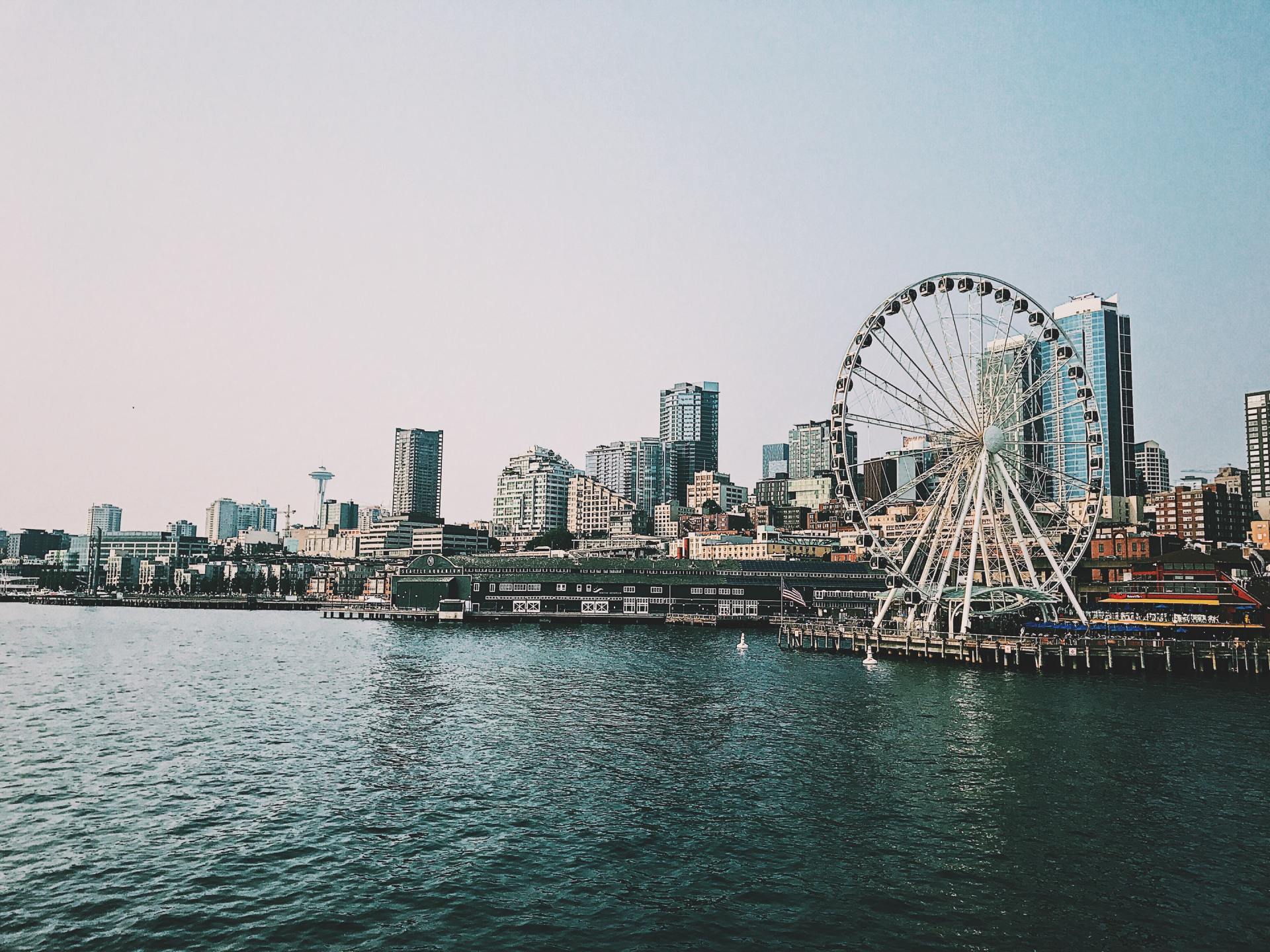A city skyline with a ferris wheel in the foreground